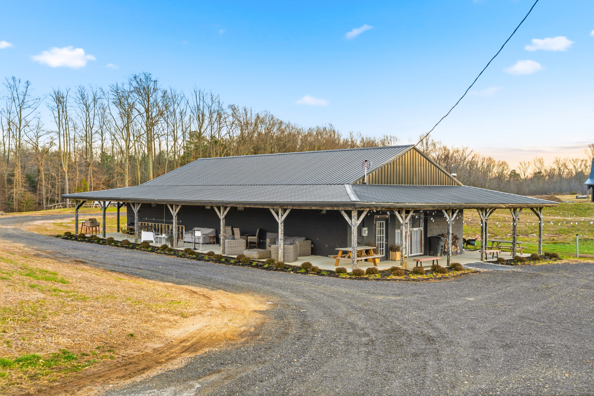 Open-air market facility on the farm in Brandywine, Maryland, with a wide covered porch, timber posts, and gathering seating